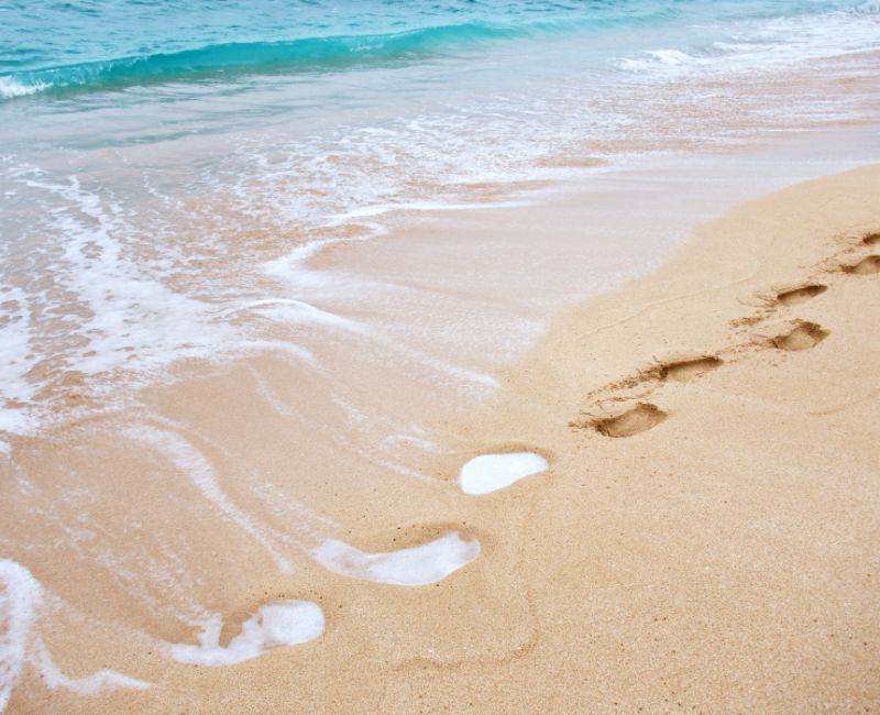 Footsteps on sandy beach